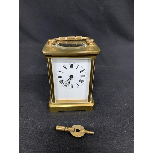 561 - Brass carriage clock and key, height 11cms