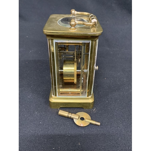 561 - Brass carriage clock and key, height 11cms