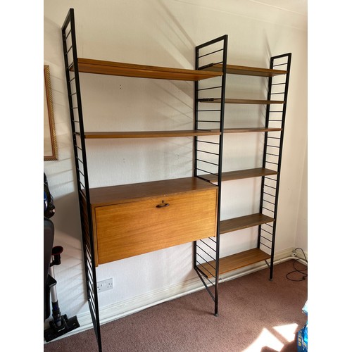 21 - A staples ladderax home office with bureau desk and cabinet compartment adjoining to a bookcase sect... 