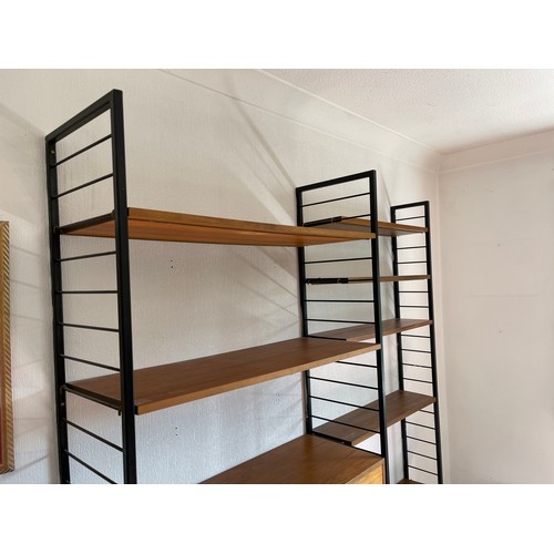 21 - A staples ladderax home office with bureau desk and cabinet compartment adjoining to a bookcase sect... 