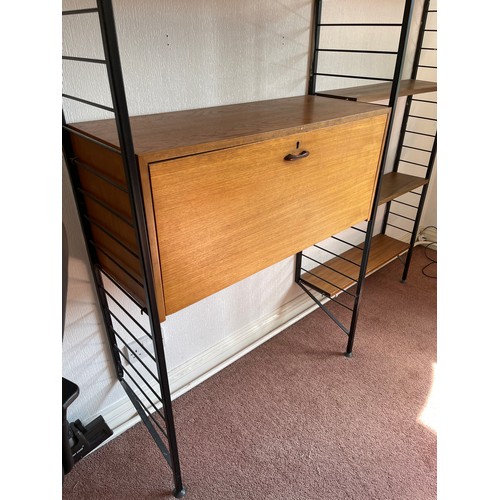 21 - A staples ladderax home office with bureau desk and cabinet compartment adjoining to a bookcase sect... 