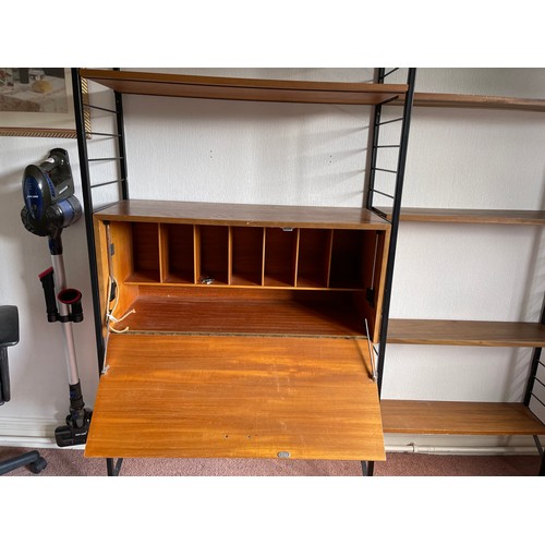 21 - A staples ladderax home office with bureau desk and cabinet compartment adjoining to a bookcase sect... 