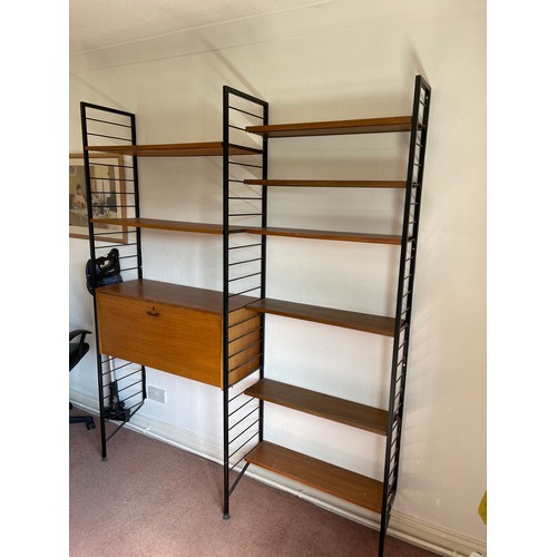 21 - A staples ladderax home office with bureau desk and cabinet compartment adjoining to a bookcase sect... 