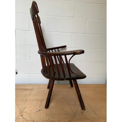 287 - Primitive low seat comb back Windsor armchair in Elm and Yew, height of seat 38 cms, width 56 cms, d... 