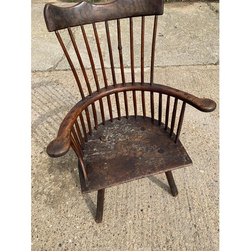 287 - Primitive low seat comb back Windsor armchair in Elm and Yew, height of seat 38 cms, width 56 cms, d... 