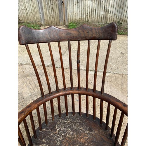 287 - Primitive low seat comb back Windsor armchair in Elm and Yew, height of seat 38 cms, width 56 cms, d... 