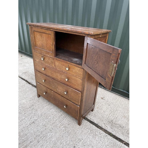 10 - An early 20th century oak linen press cupboard with two door cupboard over five drawers