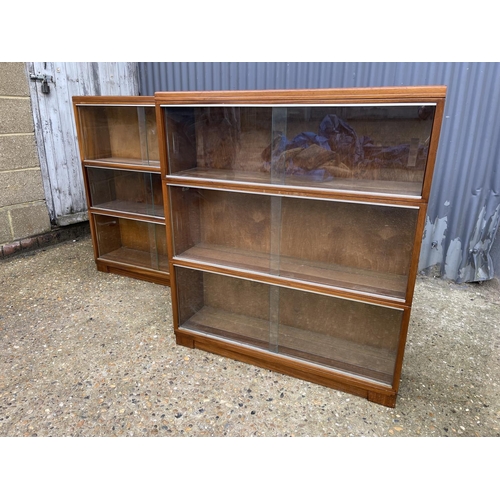 107 - A pair of minty oak three section stacking bookcases with glazed sliding doors