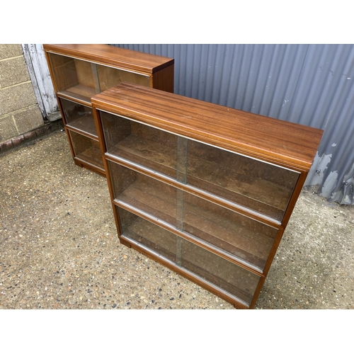 107 - A pair of minty oak three section stacking bookcases with glazed sliding doors