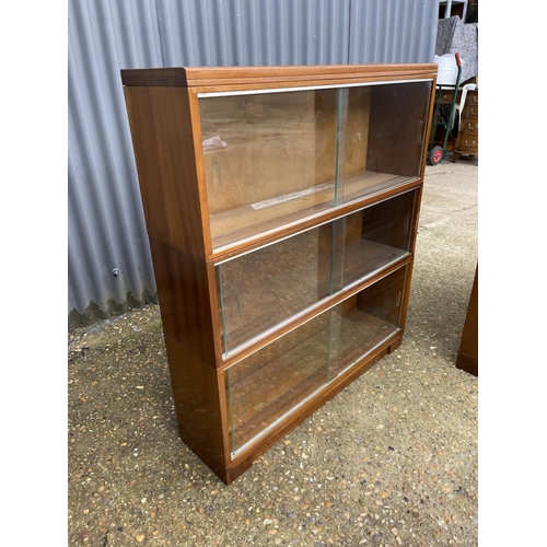 107 - A pair of minty oak three section stacking bookcases with glazed sliding doors