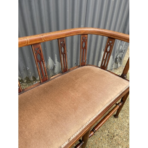 111 - An Edwardian inlaid salon sofa/love seat