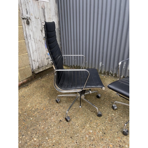 114 - A pair of EAMES style designer office swivel chairs, chrome framed with black leather seats