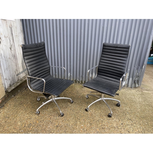 116 - A pair of EAMES style designer office swivel chairs, chrome framed with black leather seats