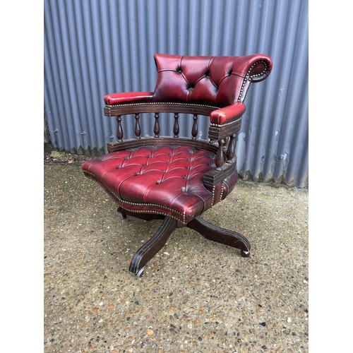 117 - A red leather chesterfield swivel office captains chair