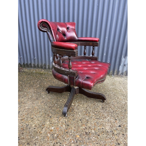 117 - A red leather chesterfield swivel office captains chair