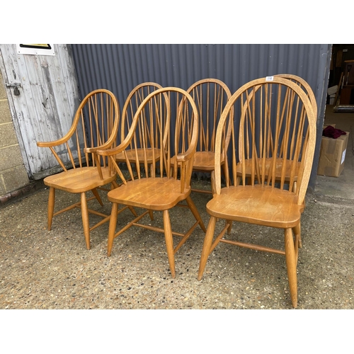 118 - A set of six hand made Ercol style stick back chairs including two carvers