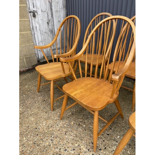 118 - A set of six hand made Ercol style stick back chairs including two carvers