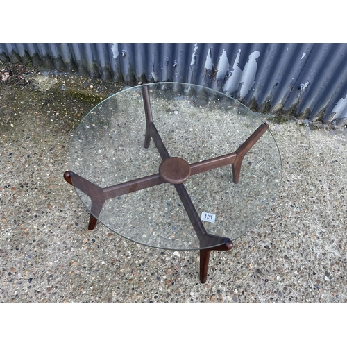 123 - A teak spider frame coffee table with glass top