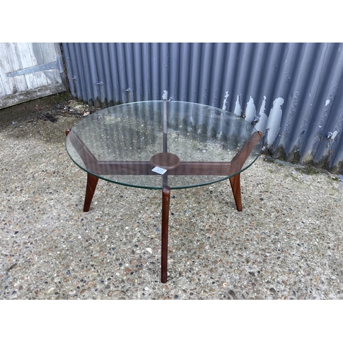 123 - A teak spider frame coffee table with glass top