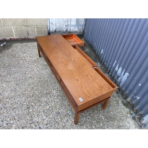124 - A teak coffee table with three two way drawers by Greeves and Thomas