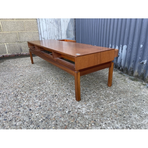 124 - A teak coffee table with three two way drawers by Greeves and Thomas