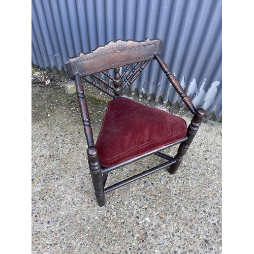 127 - A carved oak corner chair