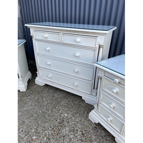 131 - A white painted bedroom set consisting of a chest of five and two matching three drawer bedsides