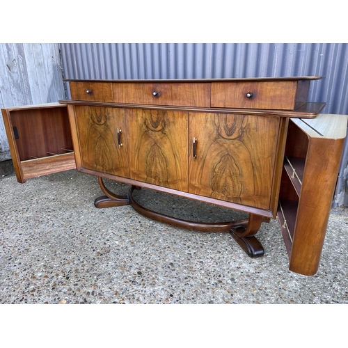 139 - A retro walnut cocktail sideboard marked HOSKINS R with sliding cocktail compartment.s to each end