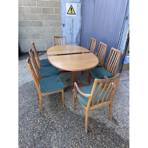 143 - A mid century g plan teak extending oval table together with a set of 8 matching g plan high back di... 