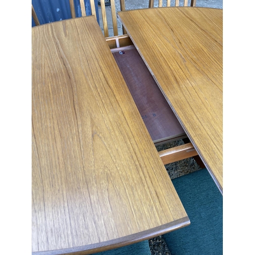 143 - A mid century g plan teak extending oval table together with a set of 8 matching g plan high back di... 
