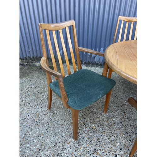 143 - A mid century g plan teak extending oval table together with a set of 8 matching g plan high back di... 