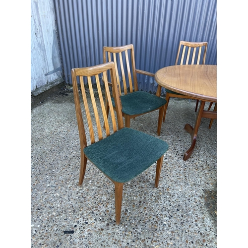 143 - A mid century g plan teak extending oval table together with a set of 8 matching g plan high back di... 