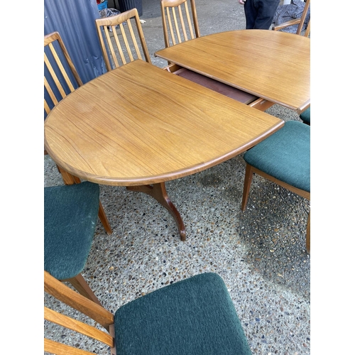 143 - A mid century g plan teak extending oval table together with a set of 8 matching g plan high back di... 