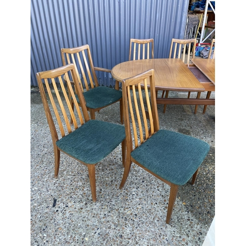 143 - A mid century g plan teak extending oval table together with a set of 8 matching g plan high back di... 