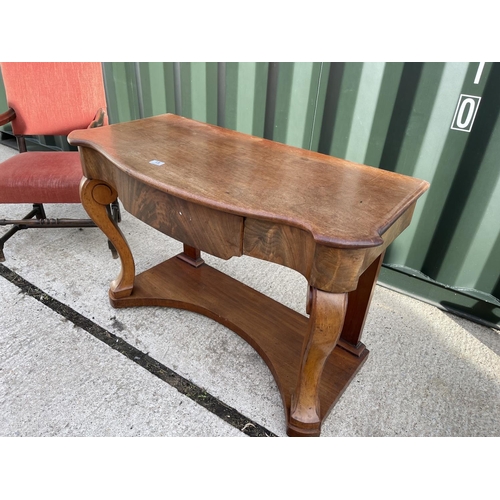 15 - An oak framed throne chair together with a mahogany serpentine hall table