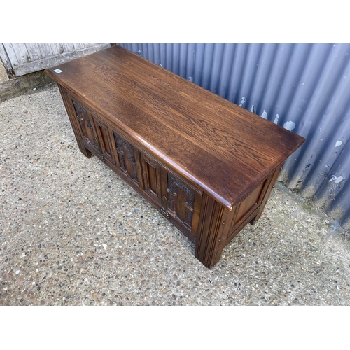 150 - A carved oak blanket box chest