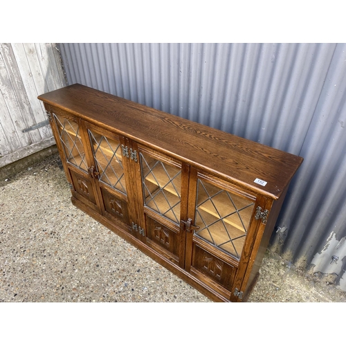 152 - An oak old charm four door leaded bookcase