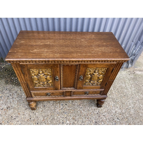 153 - A small oak two door sideboard over two drawers