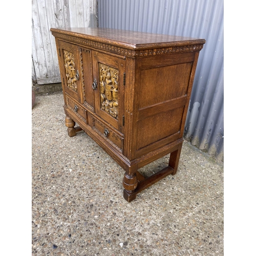153 - A small oak two door sideboard over two drawers