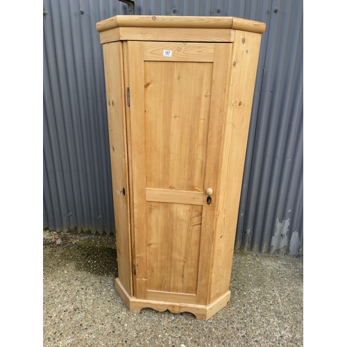 157 - A country pine corner larder cupboard with two compartments each lined with pine shelves