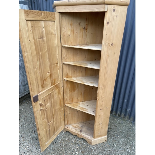 157 - A country pine corner larder cupboard with two compartments each lined with pine shelves