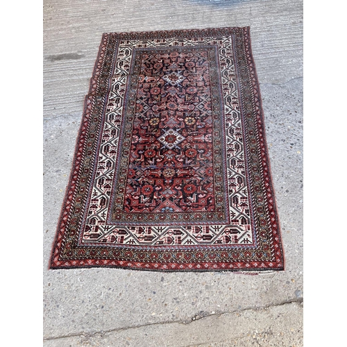 165 - A red oriemtal pattern rug 200x130