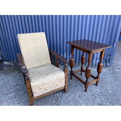 168 - A 1920's oak framed easy chair together with a oak side table