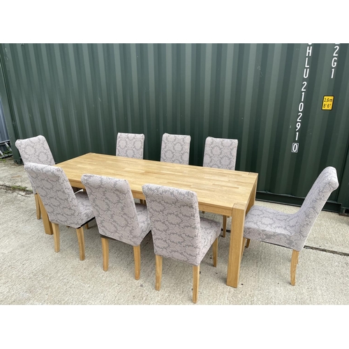 17 - A large modern light oak dining  table together with a set of 8 high back modern chairs 221x90