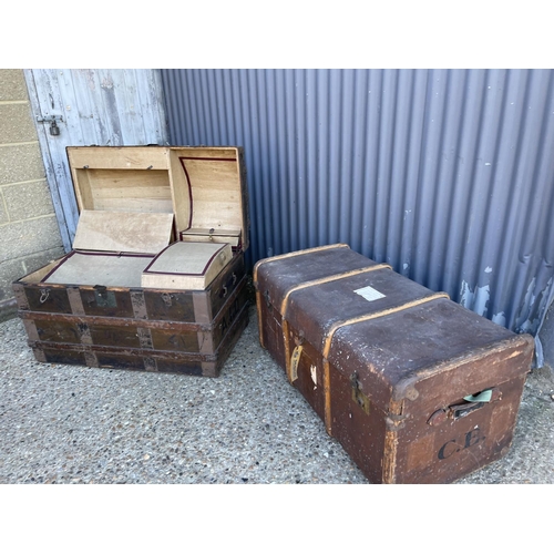 180 - Two large vintage travelling trunks, one fitted tot the interior