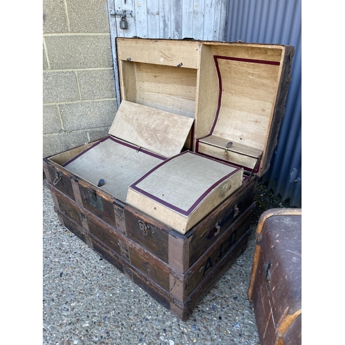 180 - Two large vintage travelling trunks, one fitted tot the interior
