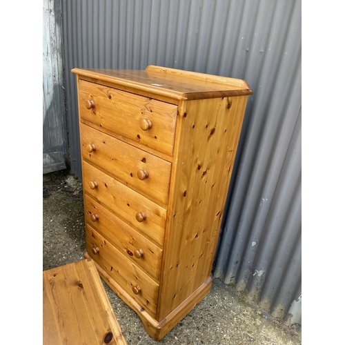 187 - A pine tallboy chest of five together with a pair of ducal pine bedside chests of three