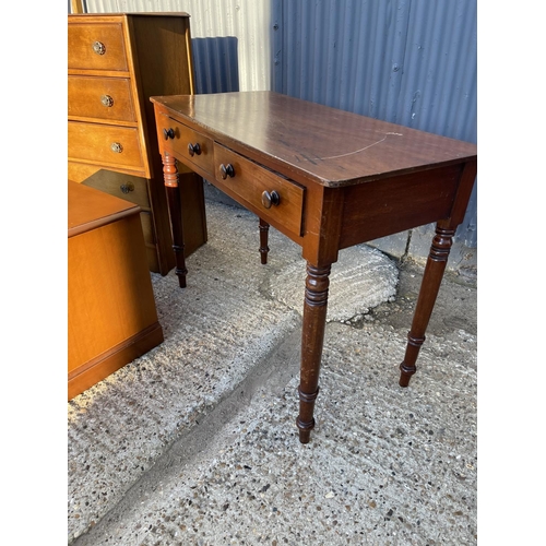 196 - An oak chest of five, a mahogany two drawer writing table and a stag bedside