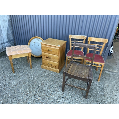 218 - A pine bedside, pine mirror, three kitchen chairs and a stool