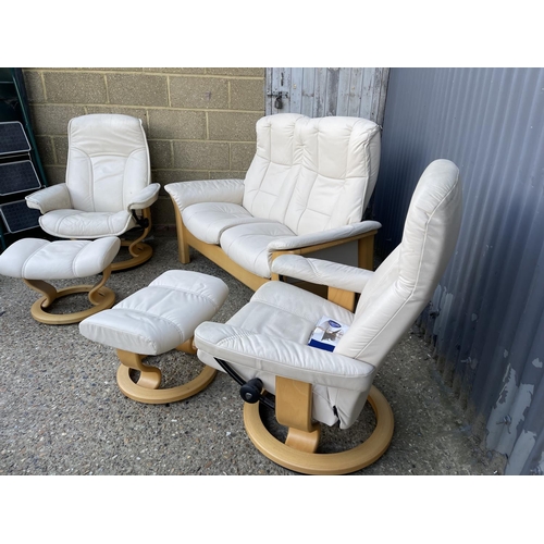 232 - A STRESSLESS cream leather three piece suite BY EKORNES consisting of a two seater sofa, two armchai... 